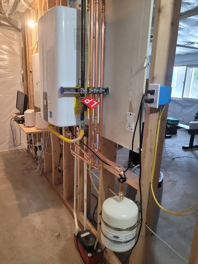 Licensed plumber repairing a kitchen sink in Adel